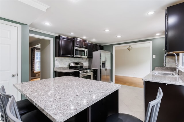 32 White Birch Cir, Chili, NY 14624 - kitchen featuring appliances with stainless steel finishes, crown molding, recessed lighting, backsplash, and light stone countertops