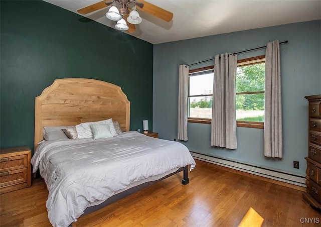 4022 W Milestrip Rd, Fenner, NY 13032 - bedroom featuring a baseboard radiator, wood finished floors, and ceiling fan
