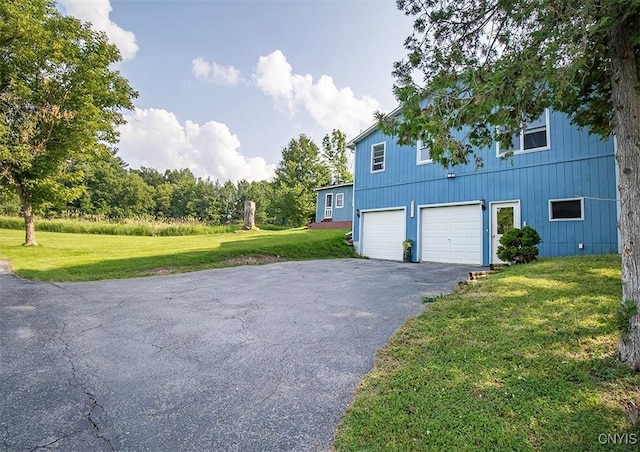 4022 W Milestrip Rd, Fenner, NY 13032 - view of property exterior featuring driveway, a garage, and a lawn