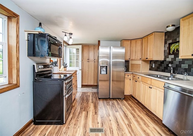 4022 W Milestrip Rd, Fenner, NY 13032 - kitchen with stainless steel appliances, light brown cabinetry, light wood-type flooring, and light countertops