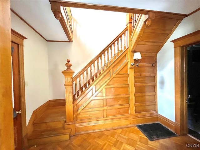 66 N Gordon St, Gouverneur, NY 13642 - stairway featuring vaulted ceiling, wooden walls, and crown molding