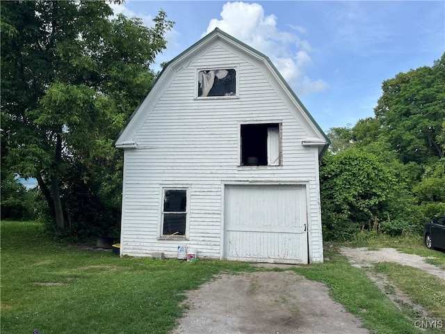 66 N Gordon St, Gouverneur, NY 13642 - view of side of property with a gambrel roof, a yard, and driveway