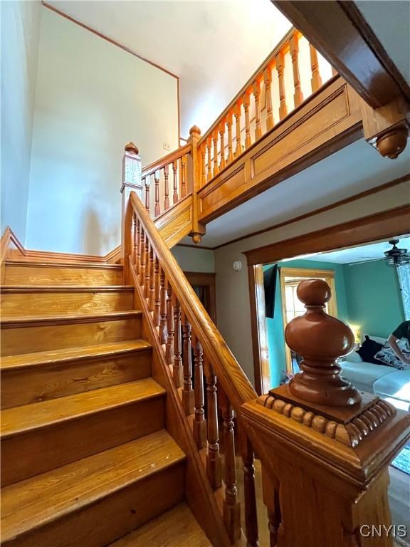 66 N Gordon St, Gouverneur, NY 13642 - staircase featuring a ceiling fan and wood finished floors