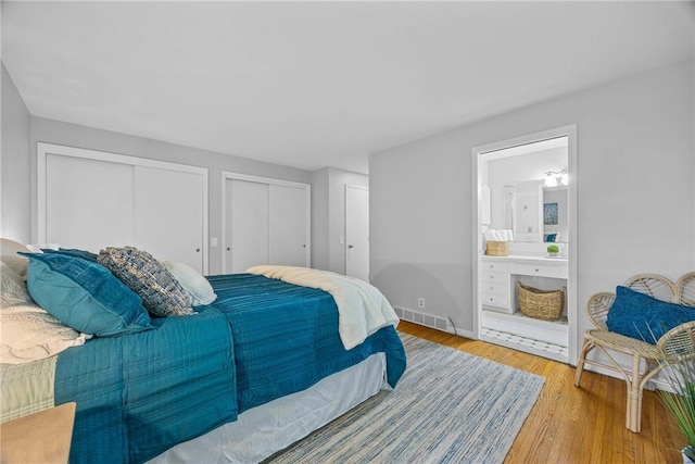 790 Oakridge Dr, Irondequoit, NY 14617 - bedroom with multiple closets, light wood finished floors, and connected bathroom