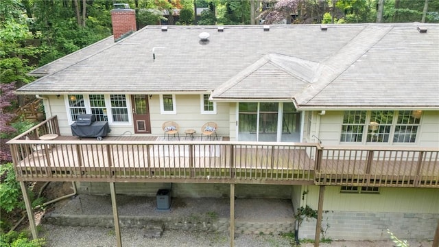 790 Oakridge Dr, Irondequoit, NY 14617 - back of property with a chimney, a wooden deck, and roof with shingles