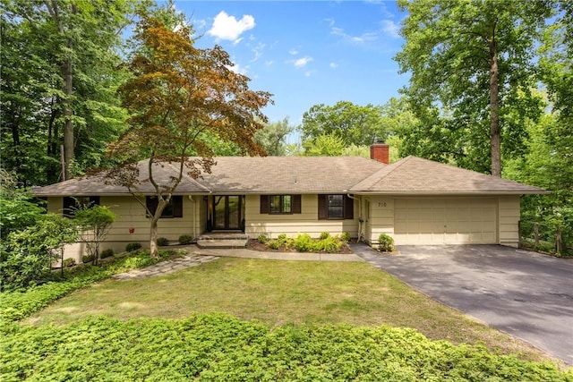 790 Oakridge Dr, Irondequoit, NY 14617 - single story home featuring asphalt driveway, a garage, a chimney, a front lawn, and roof with shingles