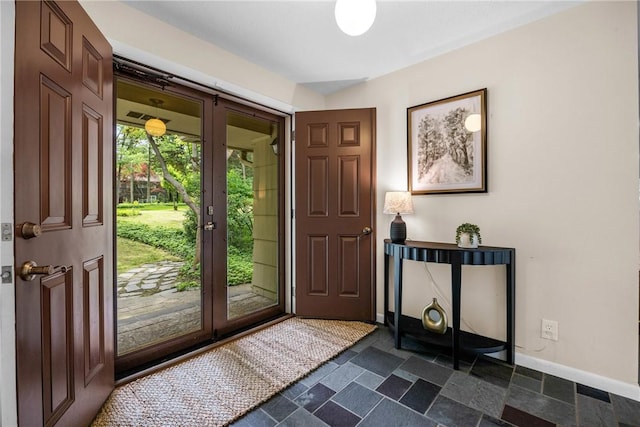 790 Oakridge Dr, Irondequoit, NY 14617 - foyer with baseboards and dark stone finish floors