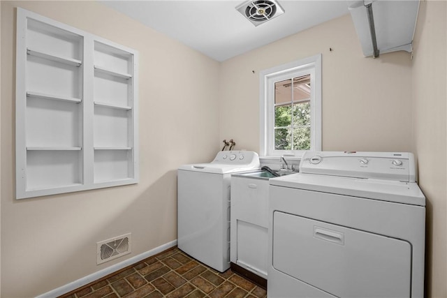 790 Oakridge Dr, Irondequoit, NY 14617 - laundry area featuring separate washer and dryer and brick patterned floors
