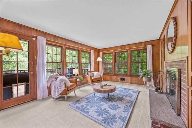 790 Oakridge Dr, Irondequoit, NY 14617 - living room with light carpet, wooden walls, and a fireplace
