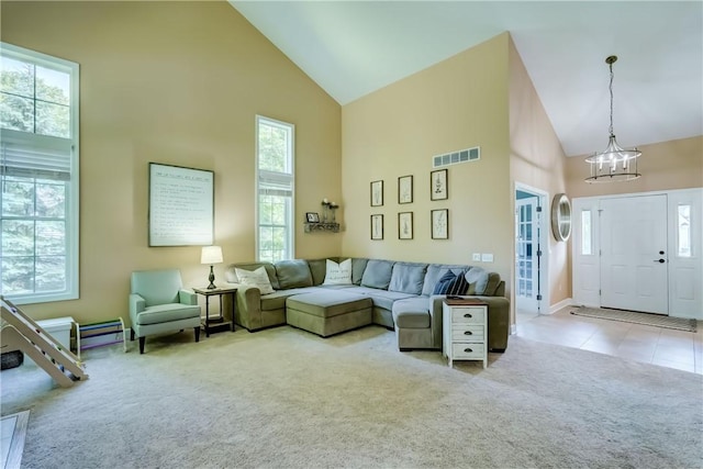 906 Lothario Cir, Webster, NY 14580 - carpeted living room featuring high vaulted ceiling, a chandelier, and tile patterned floors