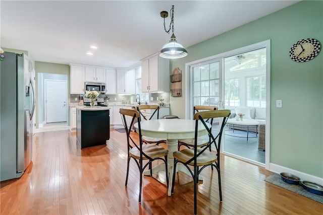 906 Lothario Cir, Webster, NY 14580 - dining area with light wood-type flooring and recessed lighting