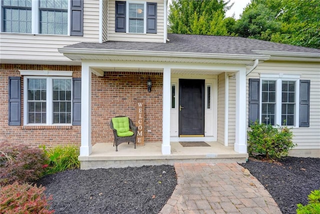906 Lothario Cir, Webster, NY 14580 - view of exterior entry featuring a porch, brick siding, and roof with shingles