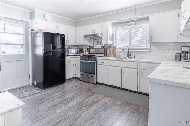 20199 County Route 181, Orleans, NY 13656 - kitchen featuring appliances with stainless steel finishes, under cabinet range hood, light wood-style floors, light countertops, and crown molding