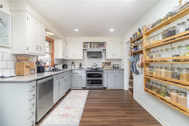 569 Marsh Rd, Pittsford, NY 14534 - kitchen with stainless steel appliances, open shelves, dark wood finished floors, white cabinetry, and backsplash
