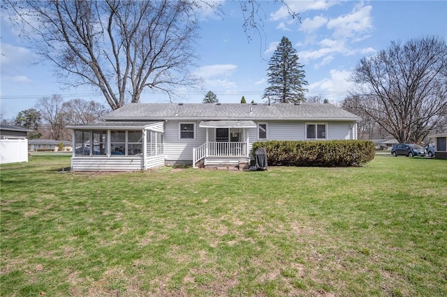 569 Marsh Rd, Pittsford, NY 14534 - rear view of property with a sunroom and a lawn