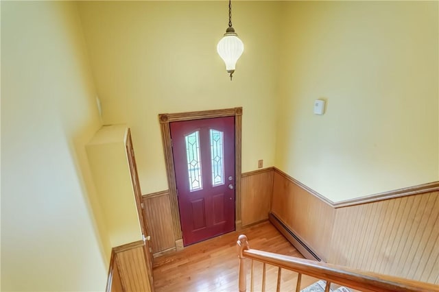 1566 Tracy Dr, Spafford, NY 13152 - foyer with a baseboard radiator, a wainscoted wall, and light wood-type flooring