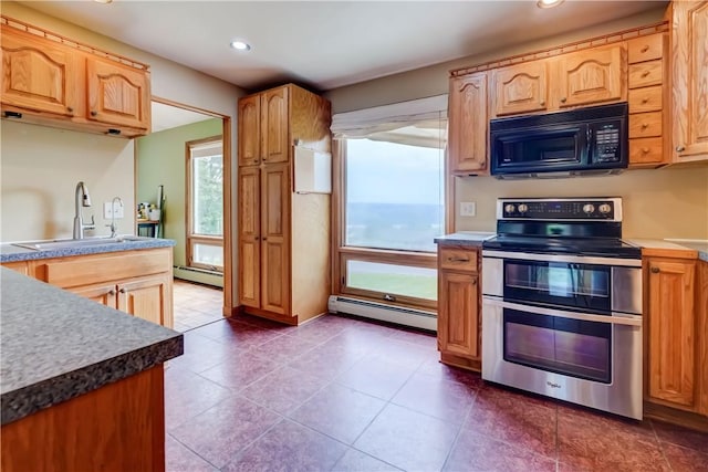 1566 Tracy Dr, Spafford, NY 13152 - kitchen featuring range with two ovens, black microwave, a baseboard heating unit, recessed lighting, and dark tile patterned flooring