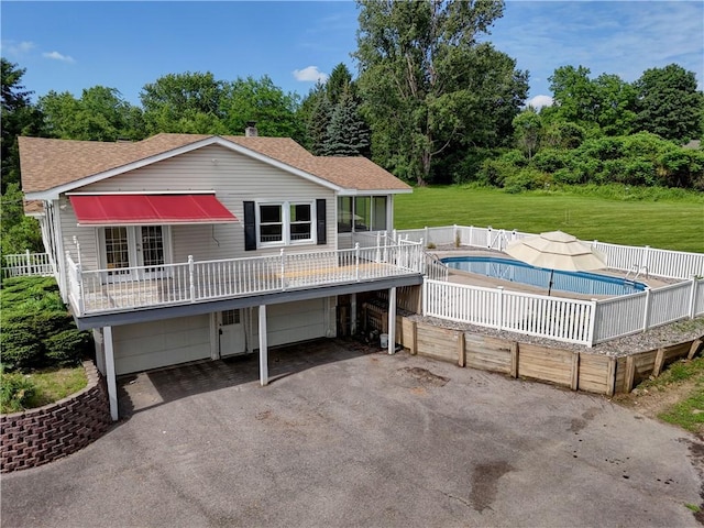 1566 Tracy Dr, Spafford, NY 13152 - view of front facade featuring an attached garage, asphalt driveway, a front lawn, a shingled roof, and french doors