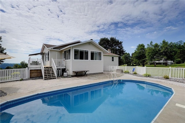 1566 Tracy Dr, Spafford, NY 13152 - rear view of property featuring a fenced backyard, a patio, a deck, and a chimney
