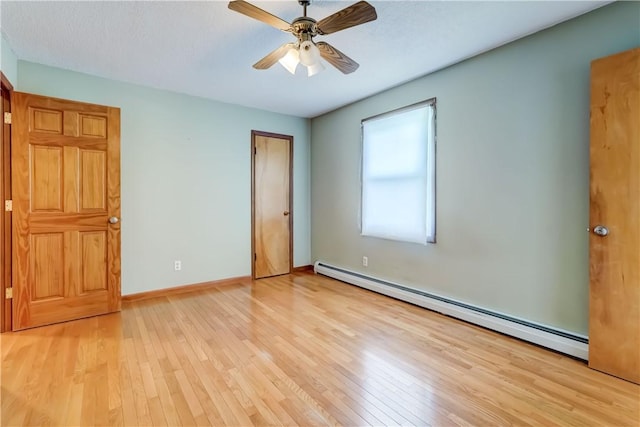 1566 Tracy Dr, Spafford, NY 13152 - unfurnished bedroom featuring a baseboard heating unit, light wood-style floors, and a ceiling fan