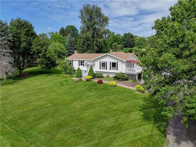 1566 Tracy Dr, Spafford, NY 13152 - view of front of house featuring a front lawn, a chimney, and a wooded view