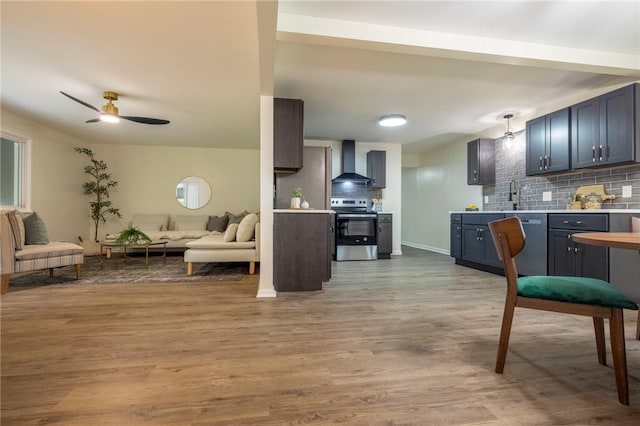 23 Kerry Park, Henrietta, NY 14534 - kitchen with stainless steel appliances, wall chimney range hood, open floor plan, tasteful backsplash, and light countertops