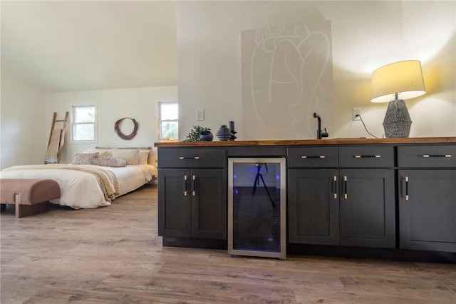 23 Kerry Park, Henrietta, NY 14534 - bedroom featuring wine cooler, wet bar, wood finished floors, and lofted ceiling