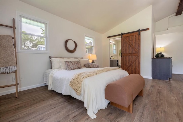 23 Kerry Park, Henrietta, NY 14534 - bedroom featuring a barn door, wood finished floors, multiple windows, vaulted ceiling, and connected bathroom