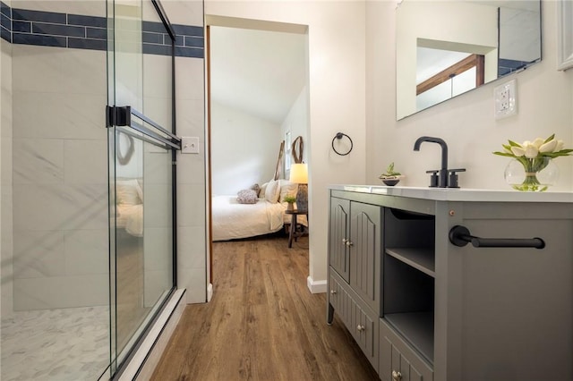 23 Kerry Park, Henrietta, NY 14534 - bathroom with wood finished floors, a stall shower, ensuite bathroom, and vanity