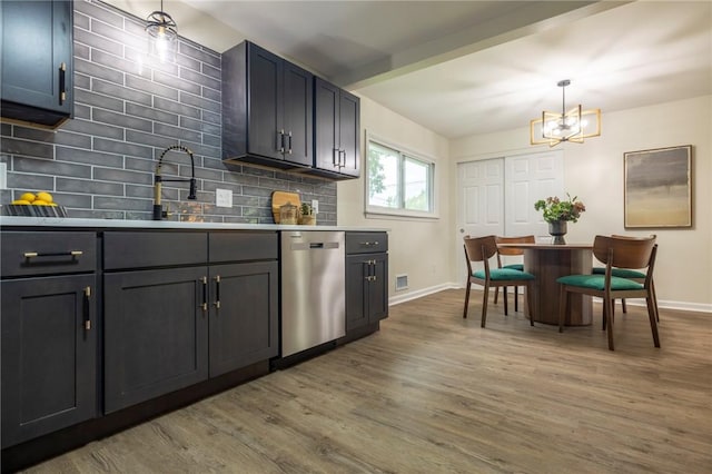 23 Kerry Park, Henrietta, NY 14534 - kitchen with dishwasher, wood finished floors, decorative backsplash, light countertops, and a chandelier
