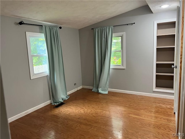 19 Beech Dr, Scriba, NY 13126 - unfurnished room featuring wood finished floors and vaulted ceiling