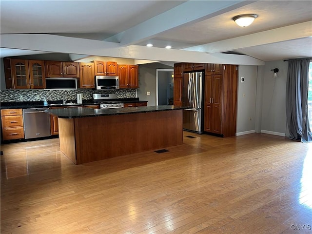 19 Beech Dr, Scriba, NY 13126 - kitchen featuring appliances with stainless steel finishes, backsplash, dark countertops, light wood-type flooring, and beam ceiling