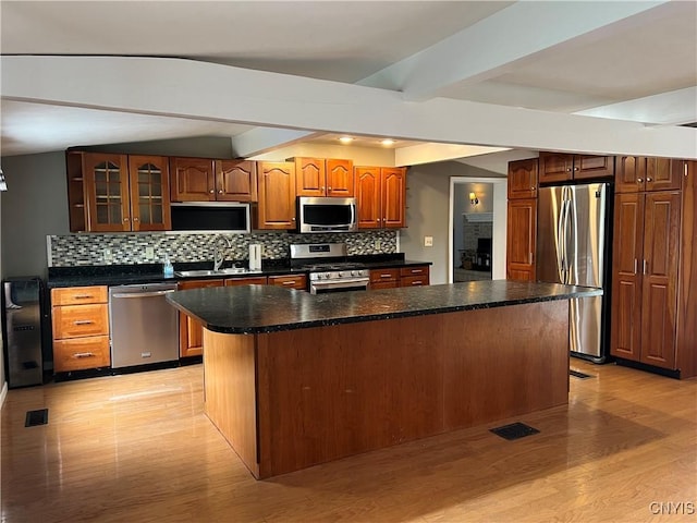 19 Beech Dr, Scriba, NY 13126 - kitchen featuring appliances with stainless steel finishes, backsplash, light wood-style flooring, beam ceiling, and a kitchen island