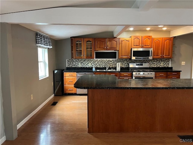 19 Beech Dr, Scriba, NY 13126 - kitchen with appliances with stainless steel finishes, tasteful backsplash, glass insert cabinets, light wood-type flooring, and recessed lighting