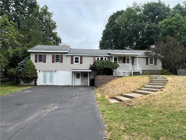19 Beech Dr, Scriba, NY 13126 - view of front of property with covered porch, asphalt driveway, and a front lawn