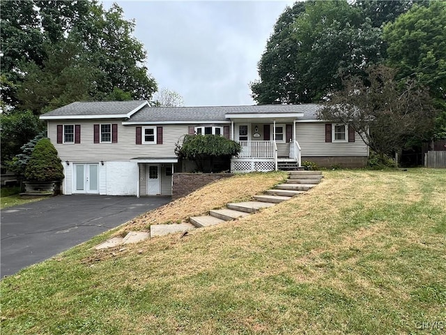 19 Beech Dr, Scriba, NY 13126 - view of front facade featuring covered porch, a front yard, driveway, and a shingled roof