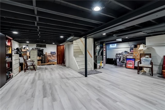 286 Park Ln, Webster, NY 14580 - basement featuring stairway, heating unit, wood finished floors, and concrete block wall