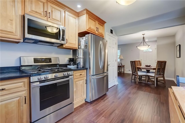 286 Park Ln, Webster, NY 14580 - kitchen featuring appliances with stainless steel finishes, dark countertops, dark wood-type flooring, recessed lighting, and hanging light fixtures