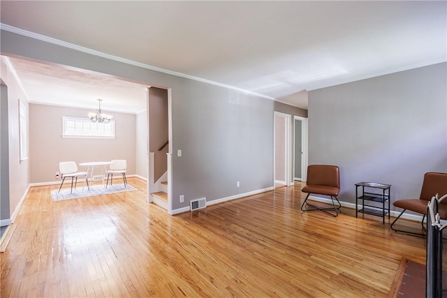 79 Meredith Ave, Brighton, NY 14618 - living area with crown molding, stairs, a chandelier, and light wood-type flooring