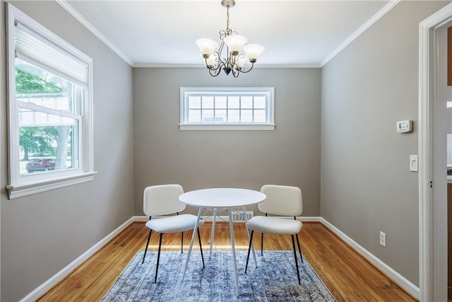 79 Meredith Ave, Brighton, NY 14618 - dining space featuring light wood-style floors, a chandelier, and ornamental molding
