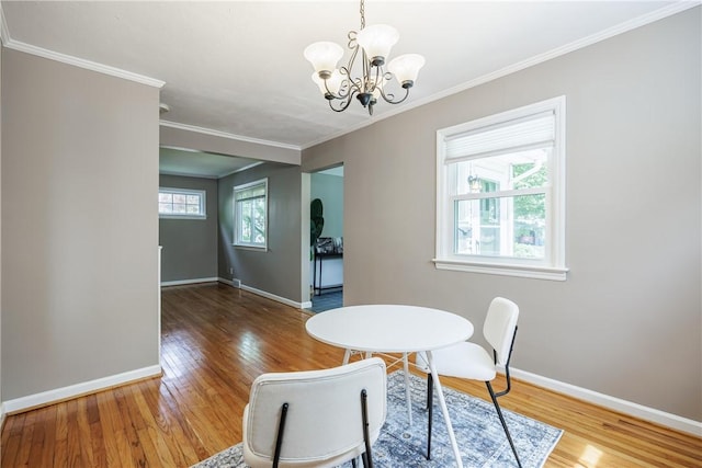 79 Meredith Ave, Brighton, NY 14618 - dining space with wood finished floors, a chandelier, and ornamental molding