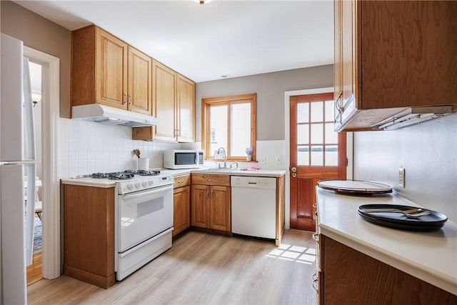 79 Meredith Ave, Brighton, NY 14618 - kitchen with white appliances, under cabinet range hood, light wood-type flooring, light countertops, and wainscoting