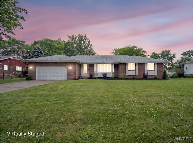 100 W Maplemere Rd, Amherst, NY 14221 - ranch-style house featuring an attached garage, brick siding, a front yard, and concrete driveway