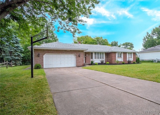 100 W Maplemere Rd, Amherst, NY 14221 - ranch-style home with a front yard, an attached garage, brick siding, and driveway
