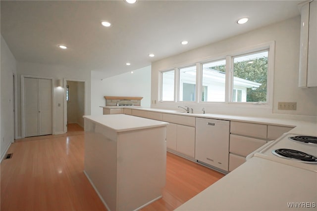 100 W Maplemere Rd, Amherst, NY 14221 - kitchen with dishwasher, a center island, light wood-style flooring, white cabinetry, and light countertops