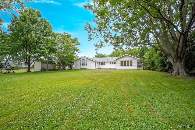 100 W Maplemere Rd, Amherst, NY 14221 - back of house featuring a lawn and a chimney