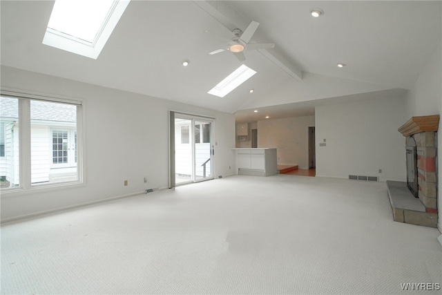 100 W Maplemere Rd, Amherst, NY 14221 - unfurnished living room featuring a skylight, a glass covered fireplace, ceiling fan, carpet floors, and recessed lighting