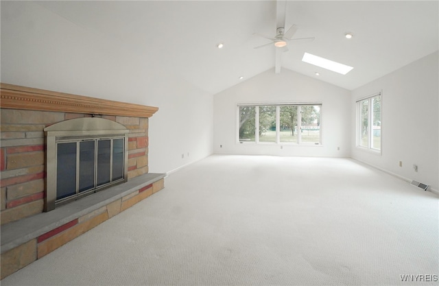 100 W Maplemere Rd, Amherst, NY 14221 - unfurnished living room featuring a glass covered fireplace, a skylight, healthy amount of natural light, and a ceiling fan