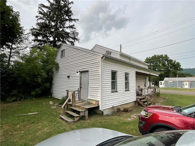 22 Jefferson St, North Dansville, NY 14437 - view of property exterior featuring a lawn