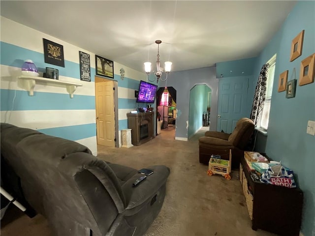 22 Jefferson St, North Dansville, NY 14437 - carpeted living area featuring a chandelier and arched walkways
